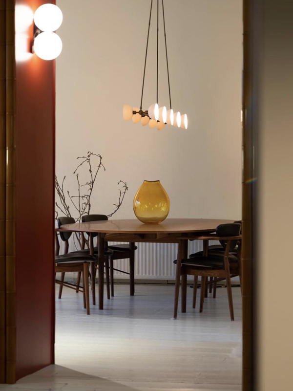 The Silver Table in walnut paired with the 108 Chair. Photocredit: Mobilia Interior