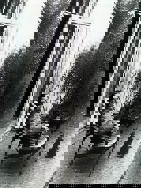 Finn Juhl sitting in the Chieftain Chair in front of his home in Ordrup north of Copenhagen.