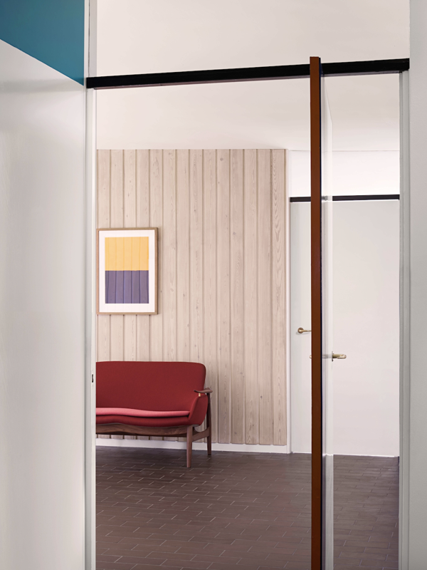 The 53 Sofa in walnut with 'Watercolour' upholstery in the colour 'Beetroot' with a cushion in the colour 'Potter's Pink'.