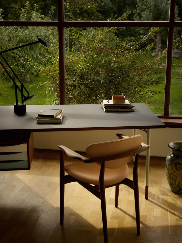 The 109 Chair in walnut with 'Nevada' leather upholstery in the colour 'Sand' paired with the Nyhavn Desk.