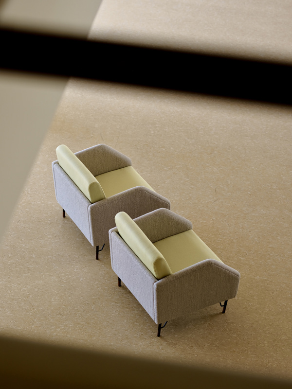 Two 77 Chairs upholstered with 'Fuse' textile in the color '233' on the seat and back cushions and 'Helia' textile in the color '421' on the body.