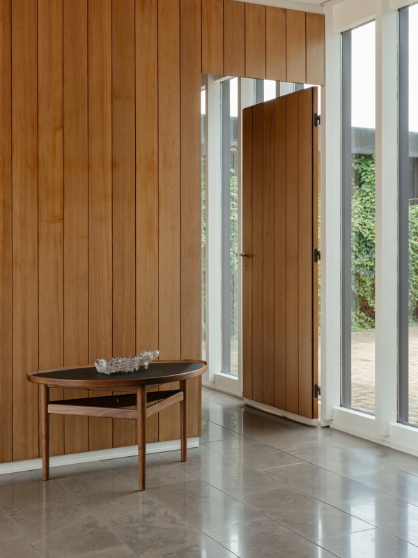 The Eye Table in walnut with black linoleum table top.