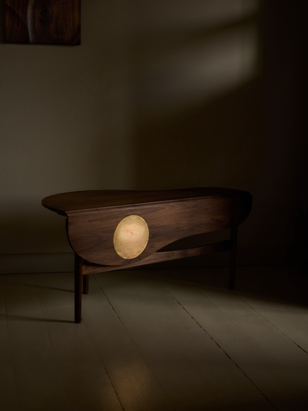 The Butterfly Table in walnut with a circular brass inlay.